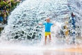 Child playing under tip bucket in water park