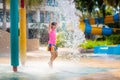 Child playing under tip bucket in water park