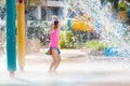 Child playing under tip bucket in water park