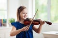 Child playing violin. Remote learning Royalty Free Stock Photo