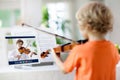 Child playing violin. Remote learning