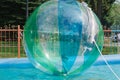 Child playing in a water ball