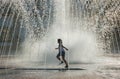 Child Playing in Water Fountain