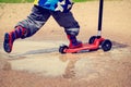 Child playing in water puddle, kids outdoors