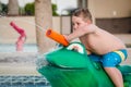 Child playing with water toy at kiddie pool Royalty Free Stock Photo