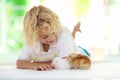 Child with rabbit. Easter bunny. Kids and pets Royalty Free Stock Photo