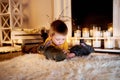 Child playing with white rabbit. Little boy petting white bunny