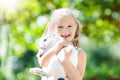 Child with rabbit. Easter bunny. Kids and pets.