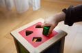 Child playing with wooden bricks in diffrent shapes and colors trying to put them into the proper hole