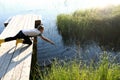 Child playing on wooden bridge by lake Royalty Free Stock Photo