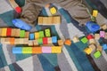 Child playing with wooden toy blocks on a carpet Royalty Free Stock Photo