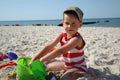 Child playint with toys on the beach