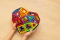 Child playng with colorful magnetic building blocks