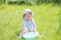 Child plays with a basin of water on the grass. Funny Baby Boy Playing Outside with Water and Bubbles. A cute baby boy is making a Royalty Free Stock Photo