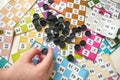 A child plays with bingo pieces,close-up a hand holds bingo pieces