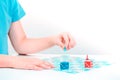 Child plays a board game on table