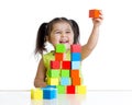 Child plays with building blocks and shows red Royalty Free Stock Photo
