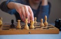 A child plays chess alone. Old wooden chessboard. Children`s hands. Chess pieces on a chessboard Royalty Free Stock Photo