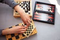 A child plays chess alone. Old wooden chessboard. Children`s hands. Chess pieces on a chessboard Royalty Free Stock Photo