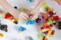 A child plays with colorful mosaic at the table. Quarantine of children at home. Top view Royalty Free Stock Photo