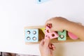 The child plays with colorful toy blocks. eco wooden toys. Little smart child playing natural toys. games for early Royalty Free Stock Photo