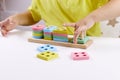 The child plays with colorful toy blocks. eco wooden toys. Little smart child playing natural toys. games for early Royalty Free Stock Photo