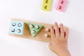 The child plays with colorful toy blocks. eco wooden toys. Little smart child playing natural toys. games for early Royalty Free Stock Photo