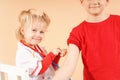 The child plays doctor and injects his older brother. Children are vaccinated