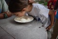 Child plays fetch a prize in a bowl of flour