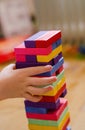 A child plays a game of wooden colored blocks, selective focus Royalty Free Stock Photo