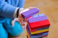 A child plays a game of wooden colored blocks, selective focus Royalty Free Stock Photo