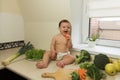 A child plays and has fun with fresh organic vegetables and fruits