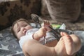 Child plays with metal spoons. little baby girl half a year playing with a metal spoon Royalty Free Stock Photo