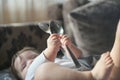 Child plays with metal spoons. little baby girl half a year playing with a metal spoon