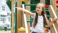 The child plays in the outdoor playground. Children play in the courtyard of a school or kindergarten. Healthy summer fun for kids Royalty Free Stock Photo