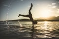 child plays and performs a capsize in the sea Royalty Free Stock Photo