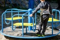 The child plays in the playground. The boy is swinging on a swing. Royalty Free Stock Photo