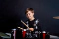 The child plays the red drums. Learning to play a musical instrument. Royalty Free Stock Photo