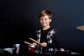 The child plays the red drums. Learning to play a musical instrument. Royalty Free Stock Photo