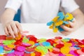 A child plays with a round colored mosaic. Game process close up. Hands close up Royalty Free Stock Photo