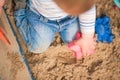 Child plays in sandbox with toys. Toddler hands with sand and copy space Royalty Free Stock Photo