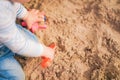 Child plays in sandbox with toys. Toddler hands with sand and copy space Royalty Free Stock Photo