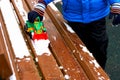 The child plays with the snow on the bench. Royalty Free Stock Photo