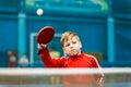 Child plays table tennis in the gym Royalty Free Stock Photo