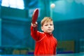 Child plays table tennis in the gym, hit the ball with racket Royalty Free Stock Photo