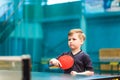 Child plays table tennis in the gym Royalty Free Stock Photo