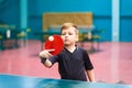 The child plays table tennis