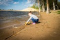 Child plays with toy car truck on the beach Royalty Free Stock Photo