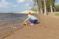 Child plays with toy car truck on the beach Royalty Free Stock Photo