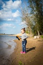 Child plays with toy car truck on the beach Royalty Free Stock Photo